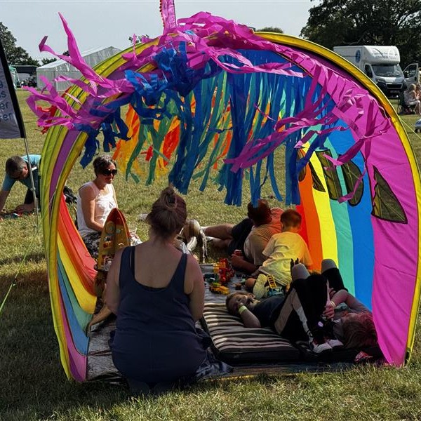Families enjoying the shade of the tickle tunnel!