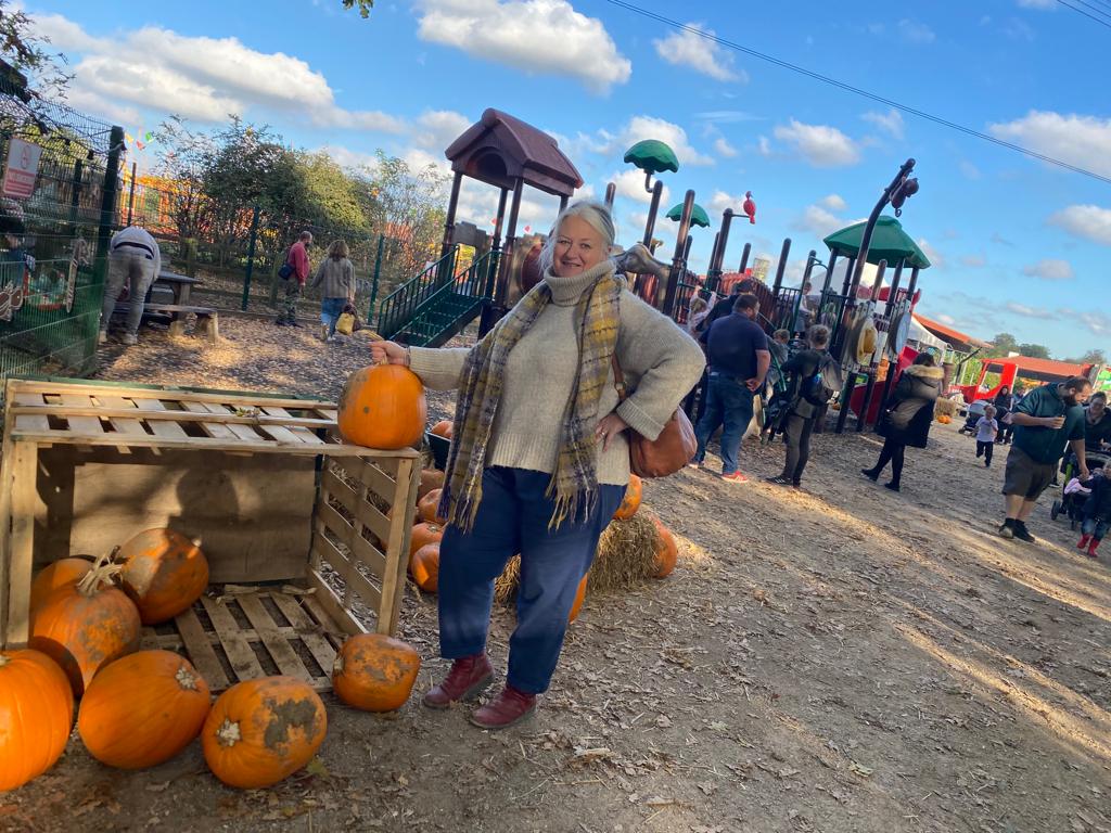 Julie picking a pumpkin